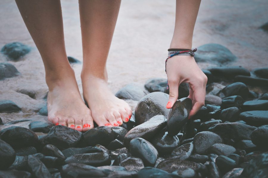 person picking up rock