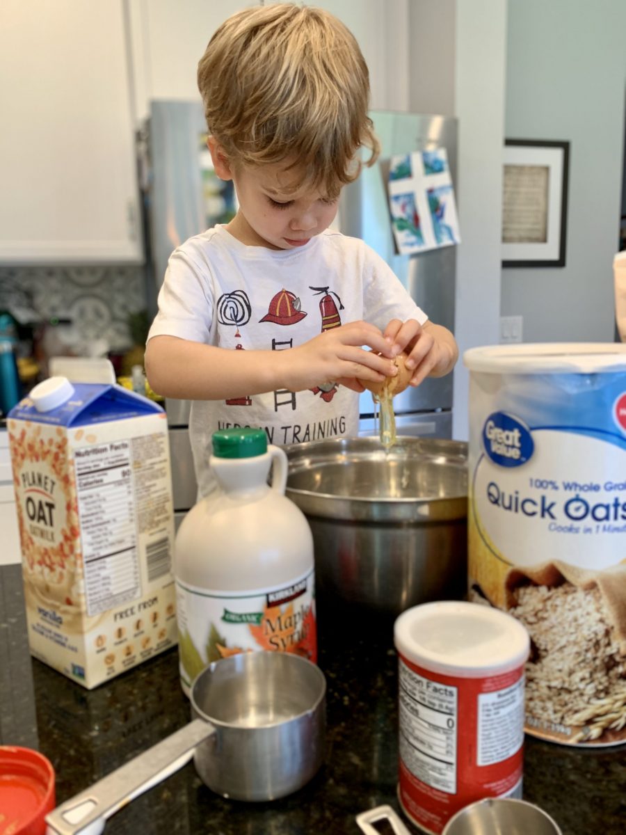 preschooler breaking an egg into bowl