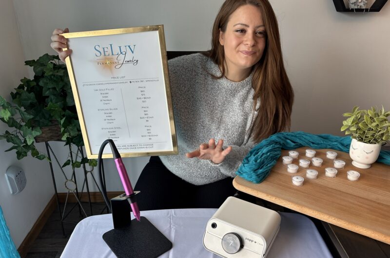Trinity Owen explaining permanent jewelry prices to customer