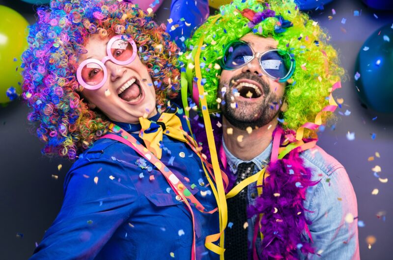 two adults dressed as clowns
